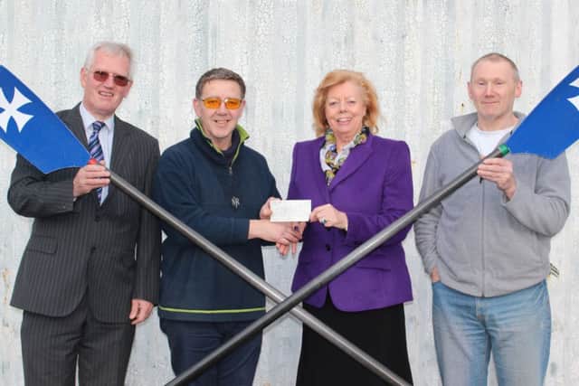 Coun Jessie Milne hands over a cheque for £2,000 to members of Gainsborough Rowing Club