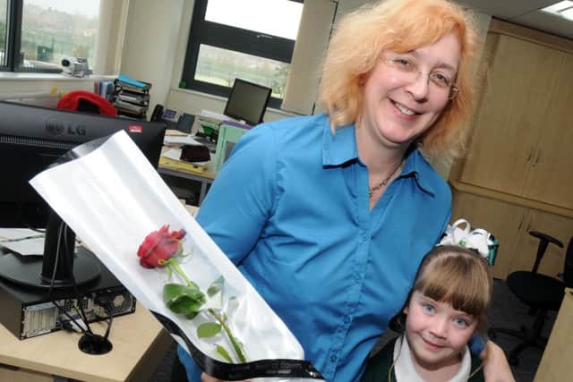 Tia Kirk presents Ryton Park Primary School assistant Kathryn Simes with a Guardian Rose