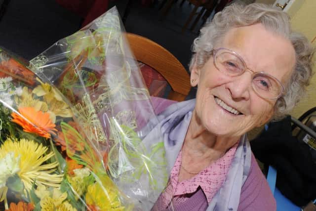 Alice Atkinson is celebrating her 102nd birthday holding her flowers from her grandson. Picture: Andrew Roe