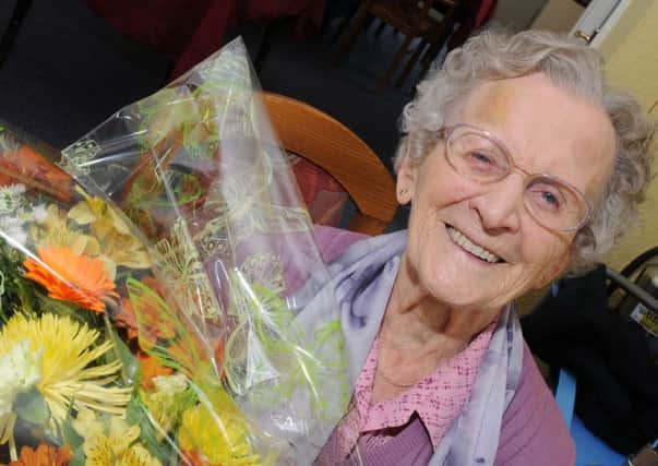 Alice Atkinson is celebrating her 102nd birthday holding her flowers from her grandson. Picture: Andrew Roe