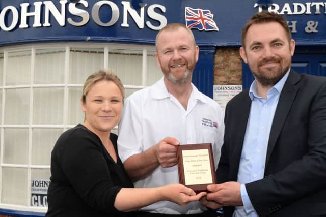 Gainsborough Standard editor Ben Green presents Rob and Teresa Johnson, with their best chip shop award. Picture: Marie Caley NGAS Chippy MC 2