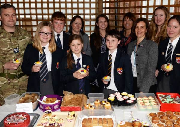 Staff and service chidren picturedalong with representatives from RAF Scampton during the Colossal CAke sale at Queen Elizabeth's High School. Picture: Marie Caley NGAS Help Heroes MC 3