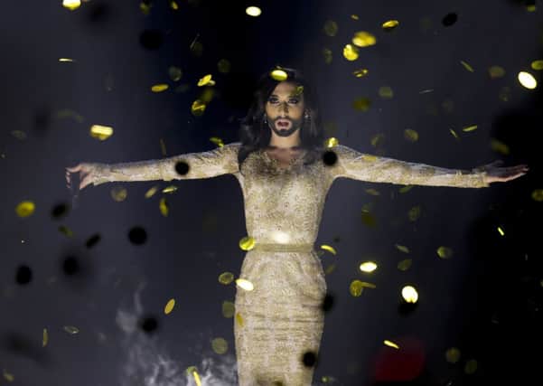 Singer Conchita Wurst representing Austria performs the song 'Rise Like a Phoenix' after winning the Eurovision Song Contest in the B&W Halls in Copenhagen, Denmark, Saturday, May 10, 2014.(AP Photo/Frank Augstein)