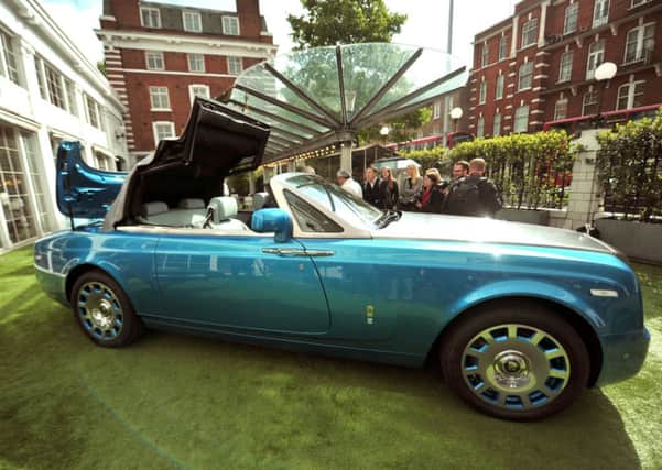 People view the new Rolls Royce Waterspeed Phantom Drophead Coupe, of which only 35 will be made, during its launch at the Bluebird Cafe, Campbell's original workshop, London. PRESS ASSOCIATION Photo. Picture date: Tuesday May 13, 2014. Photo credit should read: Anthony Devlin/PA Wire