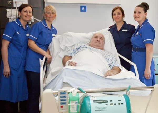 Patient Roy Murphy tries out of one of the new matresses, helped by nurses  Louise Wall, Rhiannon Boddy, Tracy Vernon and Kelly Moore