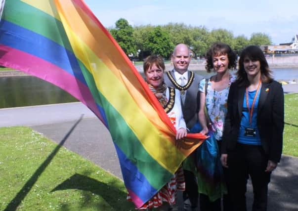 Raising the Rainbow flag are, from left: Coun Pauline Allan, chairman Notts County Council; Coun Roy Allan, chairman's escort, Karen Moss, equality officer and Claire Brown, chairman of LGBY staff network
