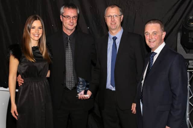 Stuart Morris and Andrew Steen from A1 Housing receive their AGSM Gas Safety Award from event host Charlie Webster (left) of Sky Sports and Chris Bielby (right), President of the AGSM