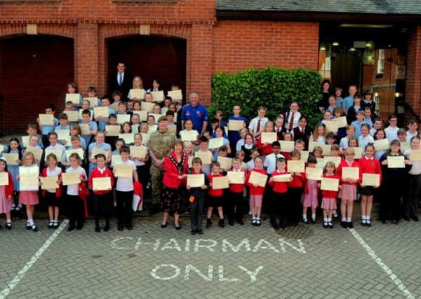School children pose with their certificates outside the Town Hall after presenting their war graves research to council officials and civic dignitaries. Picture: Barrie Codling