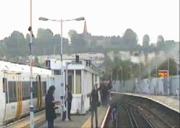 WOMAN PULLED FROM RAILWAY LINE SECONDS BEFORE TRAIN ARRIVES