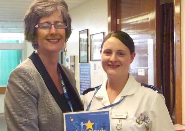 Sarah Scott, right, is presented with her DBH Star of the Month award by Dawn Jarvis, director of people and organisational development