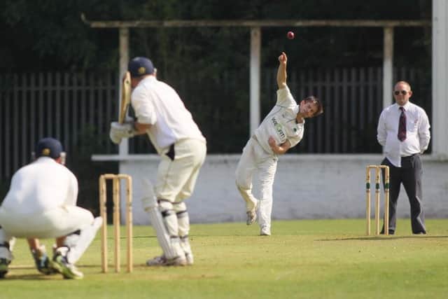 Firbeck's spinner Callum Parry bowls to Edwinstowe's skipper Andy Edwards during their rain-hit match. Picture: Richard Parkes