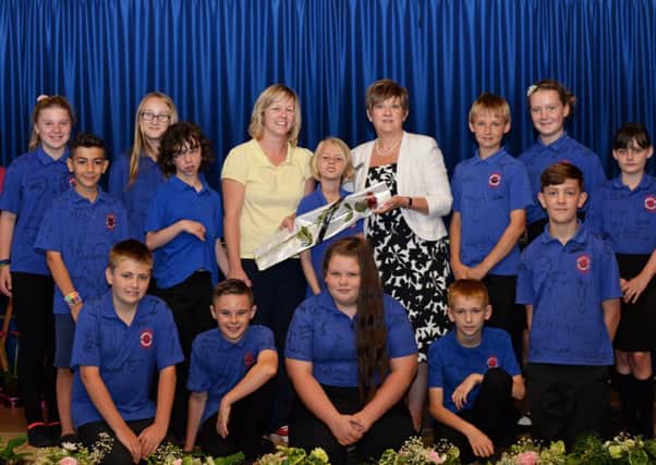 Michelle Pike and her daughter Ellie, 11, pictured presenting the Guardian Rose to Sue Osborn, Headteacher and some of the year six pupils. Picture: Marie Caley NWGU Prospect Hill MC 2