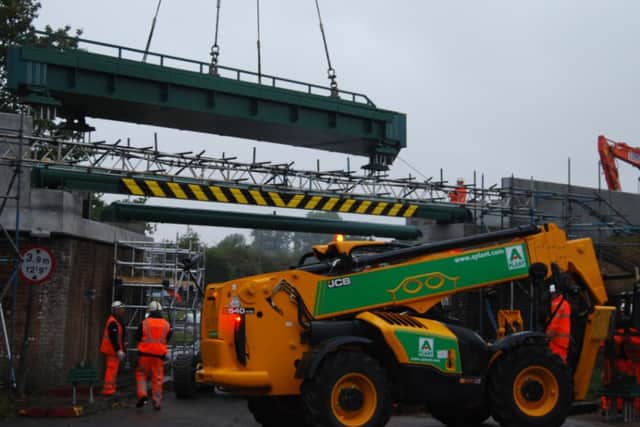 The first section of the new bridge is lowered