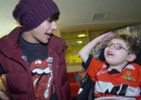 One Direction's Louis Tomlinson with Kian Critchley at Bluebell Wood Children's Hospice