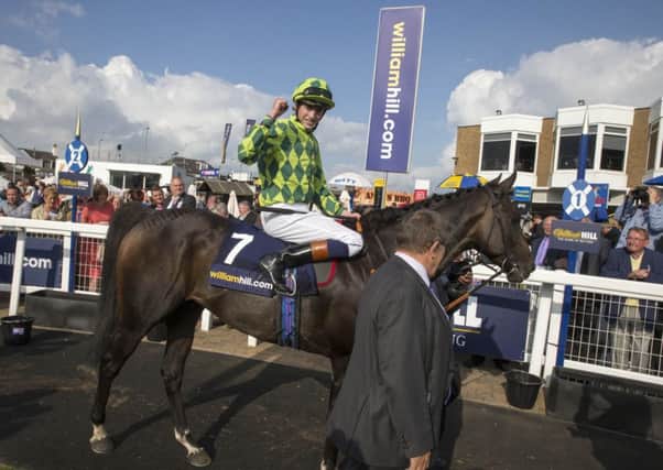 JOCKEY James Doyle celebrates after his mount, Louis The Pious, had won the big race on Saturday, the William Hill Ayr Gold Cup. (PHOTO BY: Jeff Holmes/PA Wire).