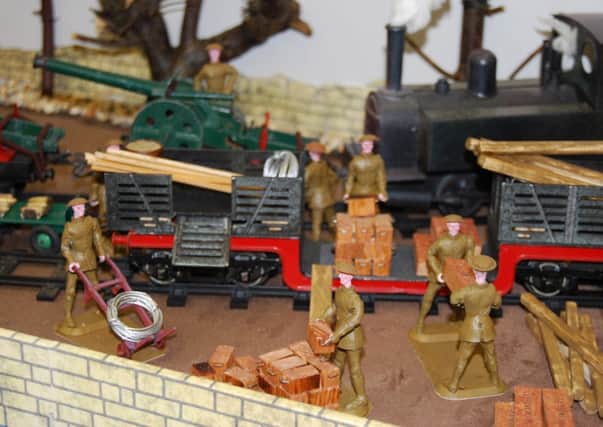 Men unloading a train on the model at the Lest We Forget World War One exhibition currently at Misterton library