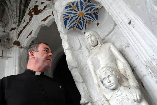 Father Nicholas Spicer with the Priory Gatehouse shrine
