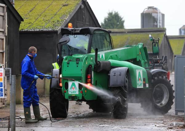 A farm vehicle is hosed down as preparations begin for a cull of ducks at a farm in Nafferton, East Yorkshire operated by Cherry Valley after a bird flu outbreak. Photo: Lynne Cameron/PA Wire
