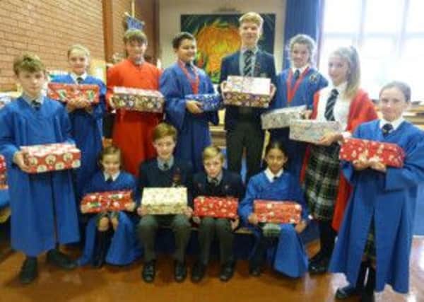 Ranby House pupils gathered in the Chapel with the mountain of shoeboxes filled with gifts for under-priviledged children