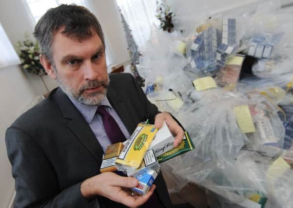 Notts Trading Standard have siezed around £50,000 of fake cigarettes. Pictured is Trading Standards Officer Paul Gretton with some of the counterfit products.