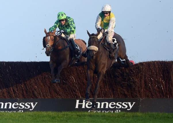 MANY Clouds (right), ridden by Leighton Aspell, jumps the last fence on his way to victory in the Hennessy Gold Cup at Newbury (PHOTO BY: Adam Davy/PA Wire)