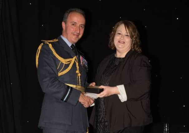 Air Commodore, Chris Luck presenting Tanya Hurst with her Outstanding Student Award in the Hairdressing category.