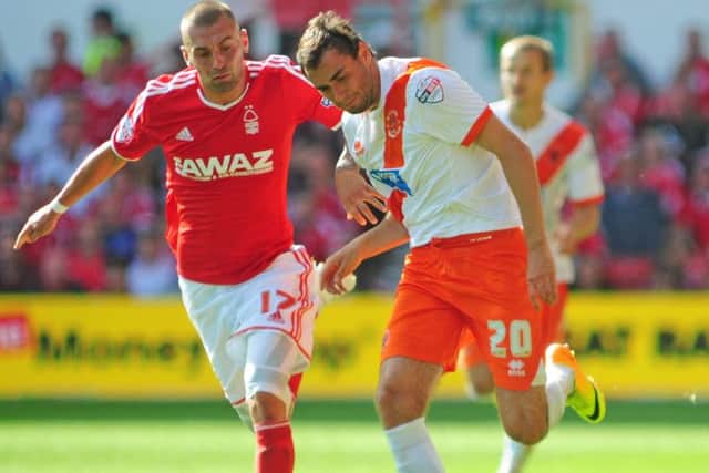 Blackpool's Sergei Zenjov shields the ball from Nottingham Forest's Jack Hunt