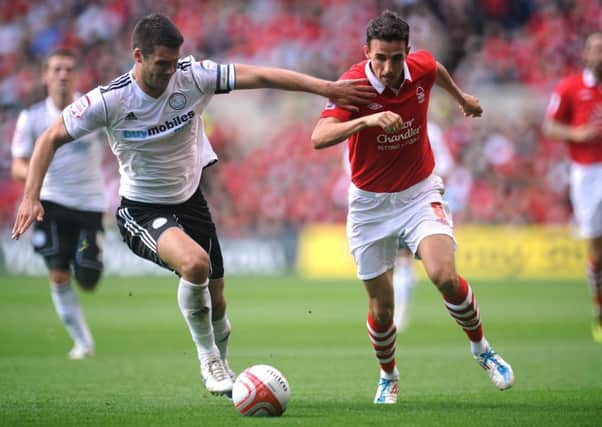 Nottingham Forest's Matt Derbyshire and Derby County's Jason Shackell in action during the npower Football League Championship match at the City Ground.
