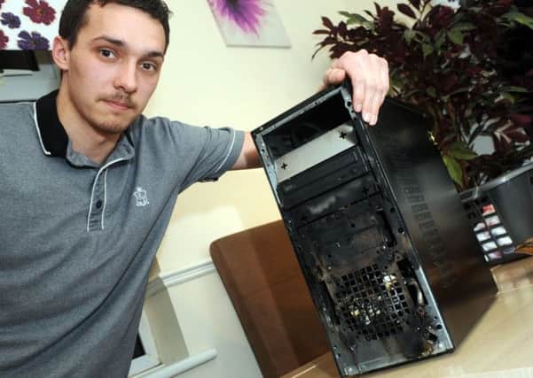 Ryan Seeley with the computer which caught fire in his Rhodesia home.