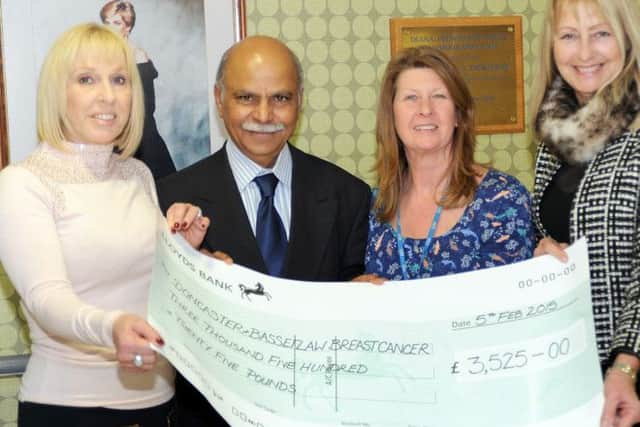 Event organisers, Anita Glasby, left, and Sue Withers, right, hand over the proceeds of their Ladies Luncheon at the Crown Hotel in Bawtry, totalling £3,525 to breast cancer surgeon Mr. Kadappa Kolar and his secretary Julie Primdore at the Bassetlaw Hospital.