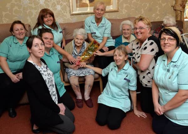 Staff at The Old Vicarge Care Home were nominated for a Guardian Rose from all the residents, pictured are some of the staff recieving the rose from resident Anne