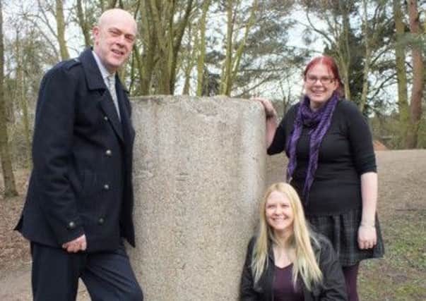 Coun John Knight, Lorraine Horsley and Emily Gillott with the Roman granite column.