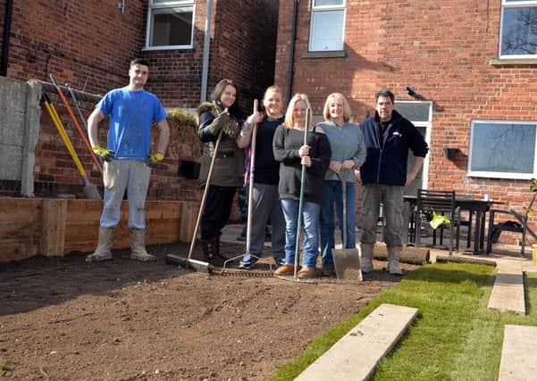 Forces Support charity give a garden makeover to Jane Elliott, pictured from left are Ritchie Howard of Forces Support, Gemma Wild, Beck Elliott, Jane Elliott, Sue Ellis and Andrew Morton of Forces Support