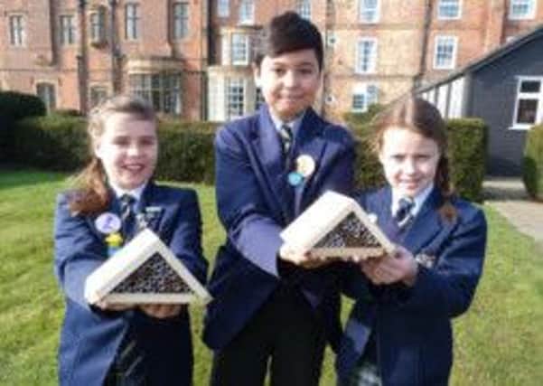 Members of the Ranby House Eco-Committee with two of the bee hotels that will be installed at the school