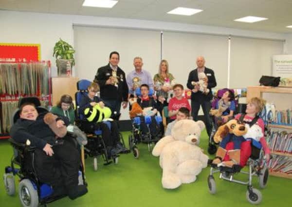 Hall-Fast owner Malcolm Hall and his wife Rachel were joined by Steelers commercial manager Mike O'Connor, pictured, to hand over the teddy bears to Fountaindale and to meet youngsters who will directly benefit from the fundraising
