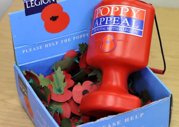 file pic - Royal British Legion Poppy Appeal collection jar, and poppy tray.  Photo by Andrew Higgins 124532c    06/11/12