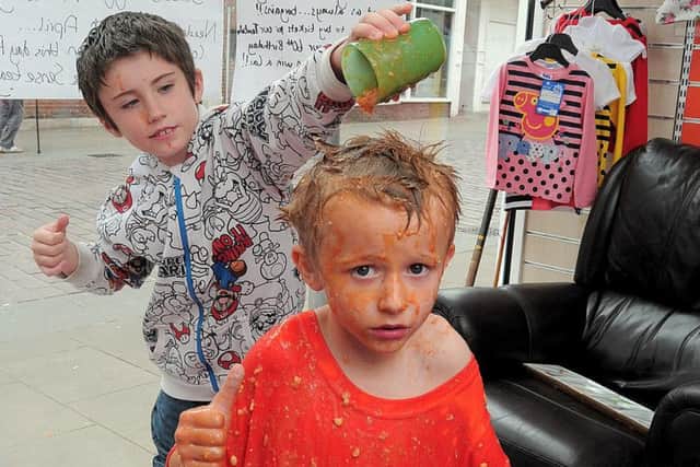 The 'Sense' Charity shop in Gainsborough which raises money to help the Deaf & Blind held a Sense charity 60th Birthday event. Highlight of the attractions was a Bean Bath challenge. The shop is in urgent need of more donated items. NGAS 25-4-15 Sense, Cory welch (5), having Baked Beans poured over him by his Brother Connor (9)