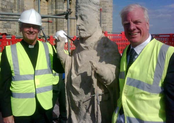 The Very Revd Philip Buckler, Dean, with Sir Edward Leigh MP, a member of the Cathedral Council, atop Lincoln Cathedral in 2011.