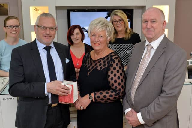 Christine Ampson is retiring from Cope Jewellers after 26 years of service, Christine is pictured recieving a gift from Andrew Cope watched by colleagues Alan Burrows, manager, Becky Daly, Amie Crooks and Margaret Young