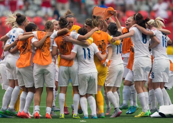 England players - including Jade Moore (no 11) - celebrate their 2-1 win over Canada following a FIFA Women's World Cup quarterfinal soccer game in Vancouver, British Columbia, Canada, on Saturday, June 27, 2015. (Darryl Dyck/The Canadian Press via AP)