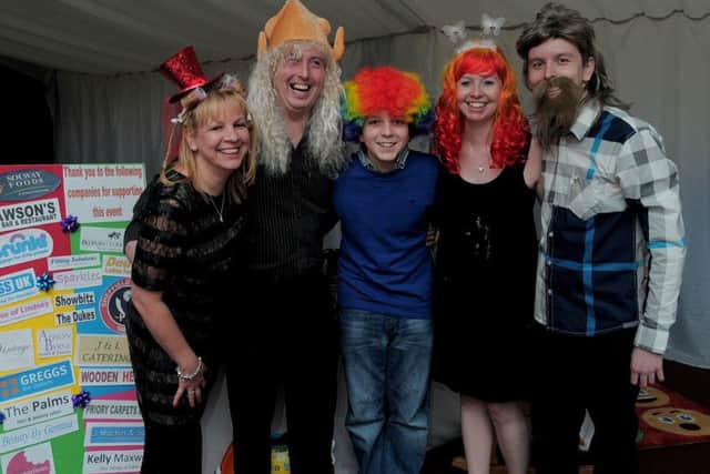 22 year old Liam Buckley from Worksop, who has incurable Bowel Cancer, is pictured with family & Friends, at North Notts Arena, Worksop.
A Fundraiser for West Park Hospital, with many of those present Wearing Fancy Hats & Wigs, for Charity.
NWGU 22-11-14 Hats, Liam Buckley & family,  L/R Janet & Darren Buckley, Liams Mum & dad, Younger brother Adam (14), Sister Emma, and Liam Buckley