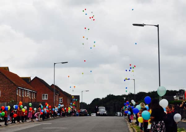 Pupils and staff from St Georges C of E Community Primary School released balloons on the day of Alfie Williams funeral as he went past the school