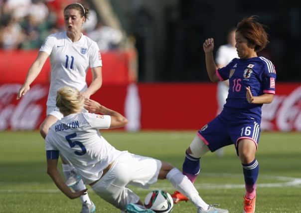 Japan's Mana Iwabuchi (16) and England's Steph Houghton compete for the ball as England's Dinnington-born star Jade Moore (11) watches during the second half of a semifinal in the FIFA Women's World Cup soccer tournament, Wednesday, July 1, 2015, in Edmonton, Alberta, Canada. Japan won 2-1. (Jeff McIntosh/The Canadian Press via AP)