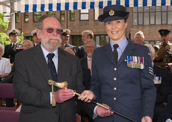 Vanessa Bray receives the Collingwood Officers Association Sword on behalf of her husband Mike from Paul Daysh, a member of the Association