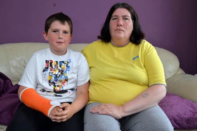 Leon Oakden-Gostling, 10 who broke his arm in the school playground pictured with Mum Carol Oakden