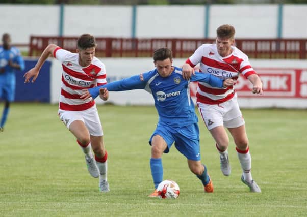 Reece Thompson in action for Frickley Athletic against Doncaster Rovers.