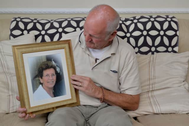 Frank Blades with a photograph of his late wife, Violet