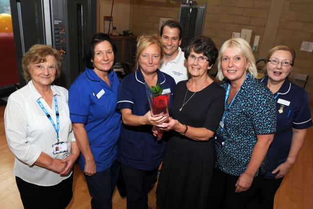 Wendy Cooke and members of the cardiac rehab team receive the Guardian rose from Marjorie Atkinson,third-right, at Bassetlaw Hospital, Worksop