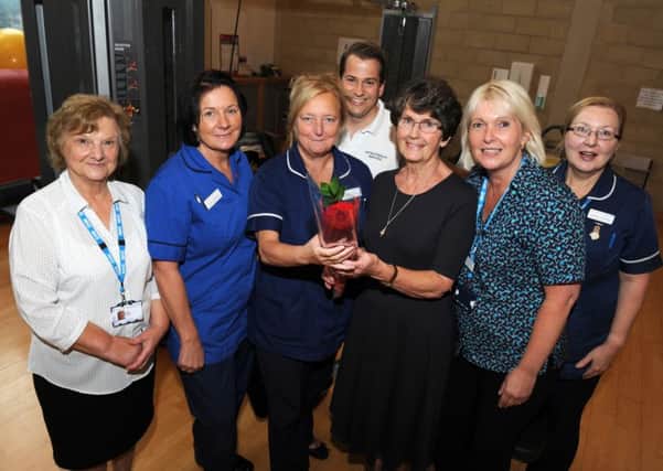 Wendy Cooke and members of the cardiac rehab team receive the Guardian rose from Marjorie Atkinson,third-right, at Bassetlaw Hospital, Worksop