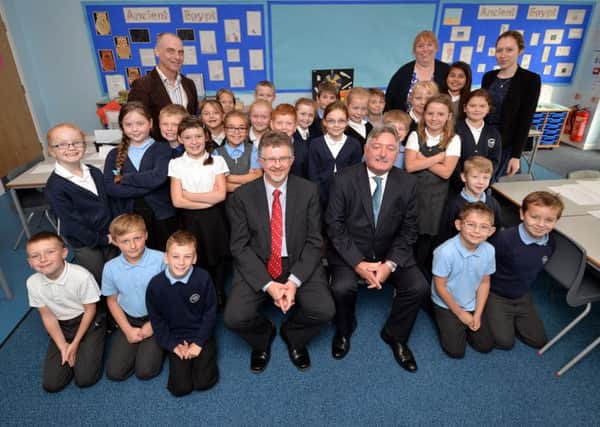 Pictured are Coun Glynn Gilfoyle, Headteacher Chris Guest and Coun Alan Rhodes with pupils and teachers in the school's new classroom